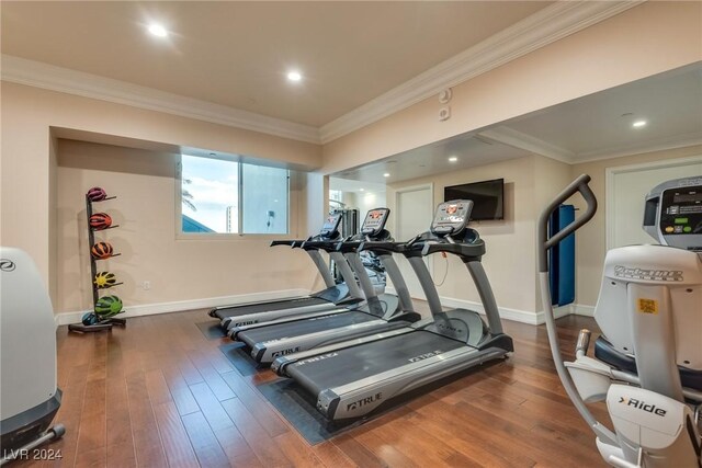 exercise room with crown molding and dark hardwood / wood-style floors