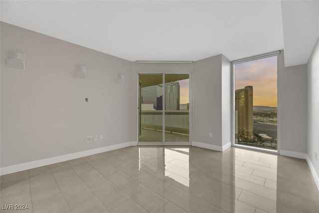 spare room featuring light tile patterned floors