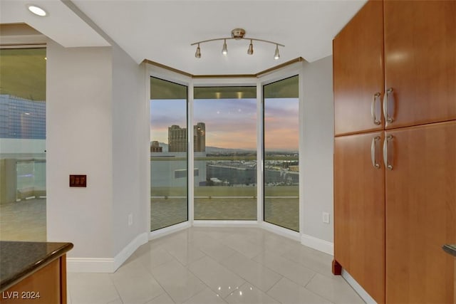 unfurnished dining area with floor to ceiling windows and light tile patterned floors