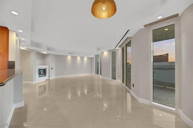 unfurnished living room featuring light tile patterned floors