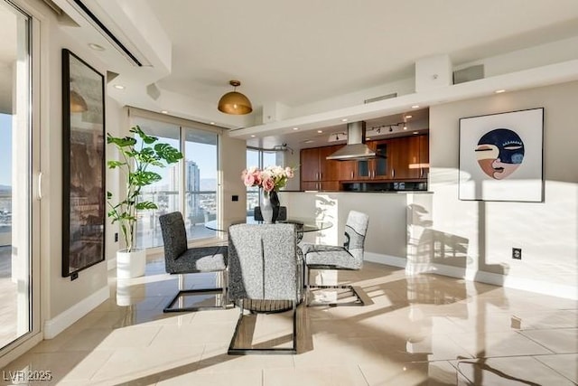 dining room with baseboards and recessed lighting