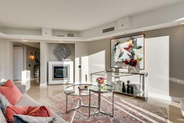 living room with recessed lighting, baseboards, visible vents, and a glass covered fireplace