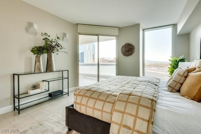 bedroom with access to outside, baseboards, expansive windows, and light tile patterned floors