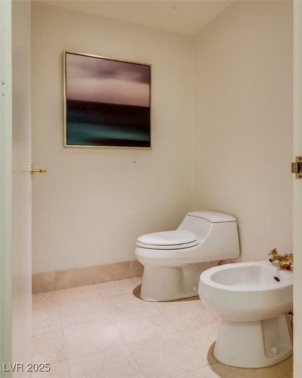 bathroom featuring a bidet, tile patterned flooring, and toilet