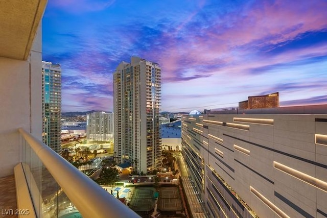 balcony at dusk with a view of city