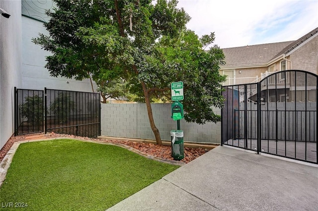 view of gate featuring a yard