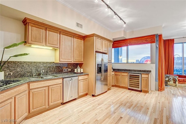 kitchen with ornamental molding, stainless steel appliances, sink, light hardwood / wood-style flooring, and wine cooler