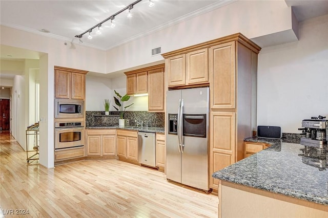 kitchen featuring kitchen peninsula, stainless steel appliances, light hardwood / wood-style flooring, and crown molding