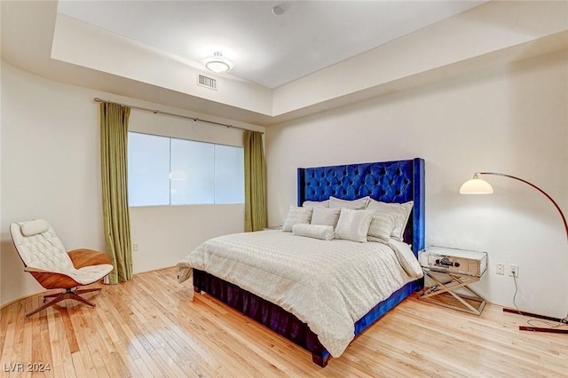 bedroom with hardwood / wood-style flooring