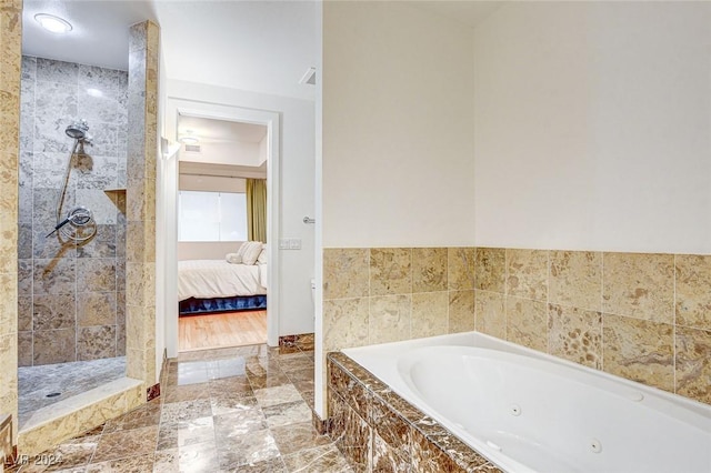 bathroom featuring separate shower and tub