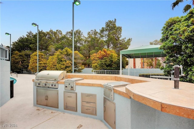 view of patio / terrace featuring a gazebo, an outdoor kitchen, and grilling area