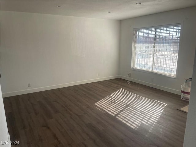 unfurnished room with dark hardwood / wood-style floors