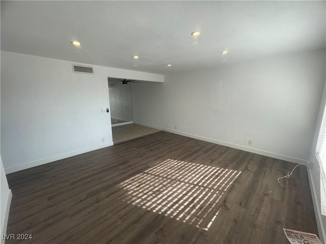 unfurnished room with dark wood-type flooring