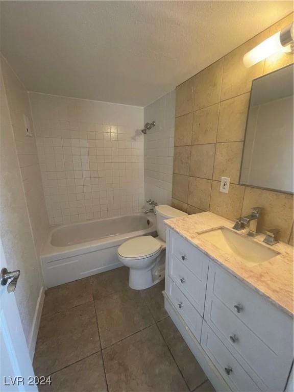 full bathroom featuring vanity, tile patterned flooring, decorative backsplash, tiled shower / bath combo, and toilet