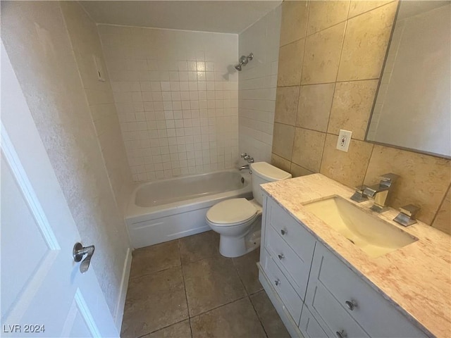 full bathroom featuring backsplash, vanity, tiled shower / bath combo, tile patterned flooring, and toilet