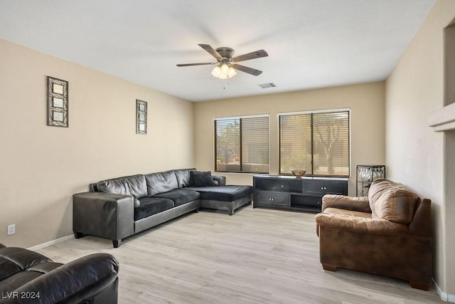 living room featuring ceiling fan and light hardwood / wood-style floors