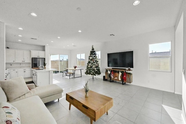 tiled living room featuring sink