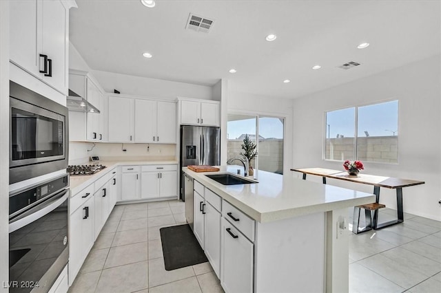 kitchen featuring white cabinetry, an island with sink, and appliances with stainless steel finishes