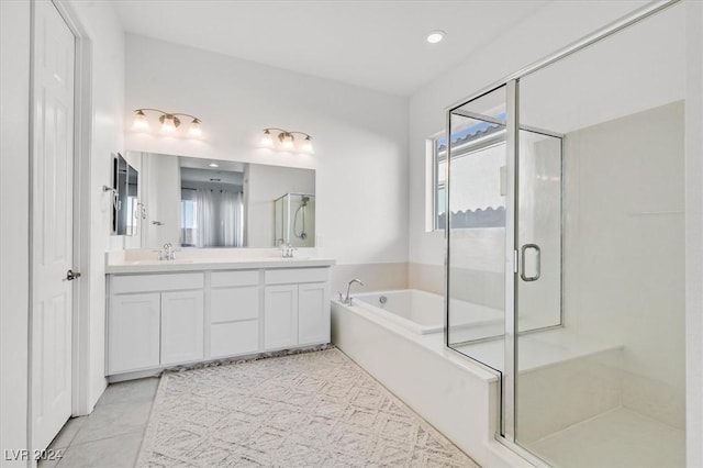 bathroom featuring vanity and independent shower and bath