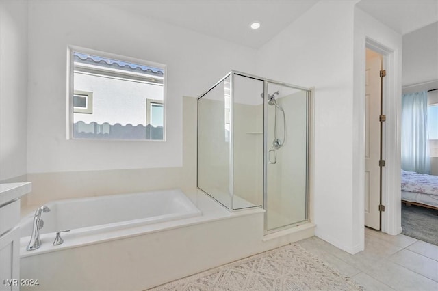 bathroom with tile patterned floors, plenty of natural light, and independent shower and bath