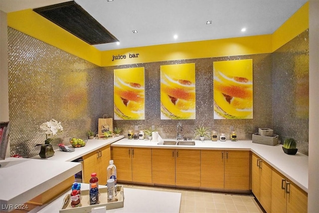 bathroom with sink and tasteful backsplash