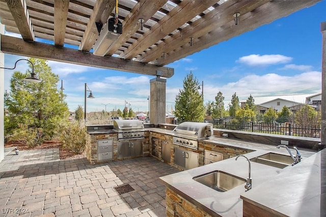 view of patio with sink, a pergola, area for grilling, and a grill