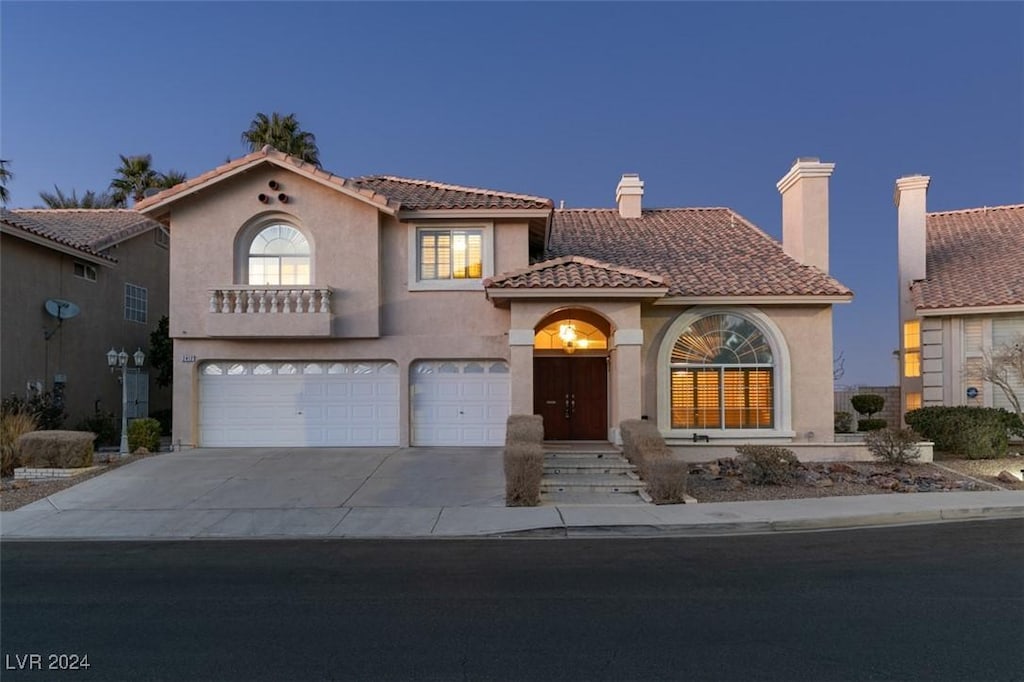 mediterranean / spanish home featuring a garage