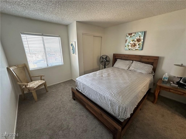 bedroom with carpet, a textured ceiling, and a closet