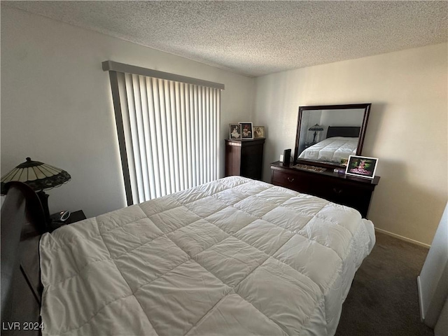 bedroom with carpet flooring and a textured ceiling