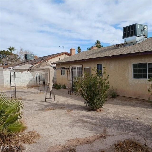 rear view of property with central air condition unit