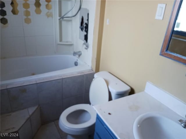 full bathroom with vanity, tiled shower / bath combo, toilet, and tile patterned flooring