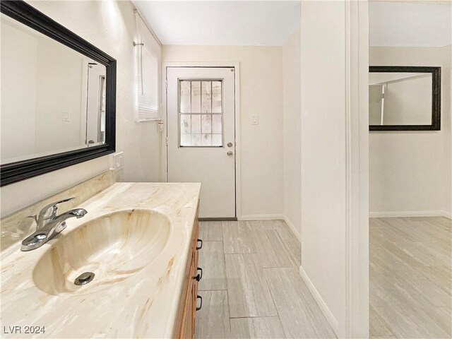 bathroom with wood-type flooring and vanity