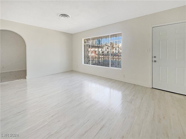unfurnished room with light wood-type flooring