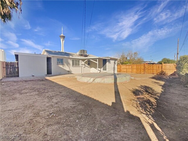 rear view of property with cooling unit and a patio area