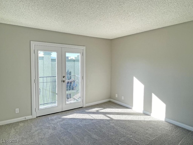 entryway featuring a textured ceiling, light carpet, and french doors