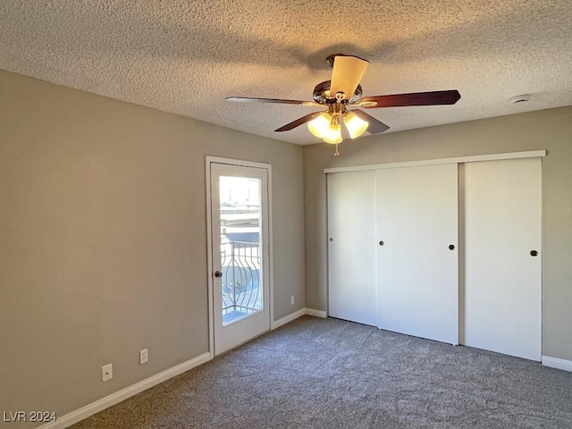 unfurnished bedroom with carpet, a textured ceiling, a closet, and ceiling fan