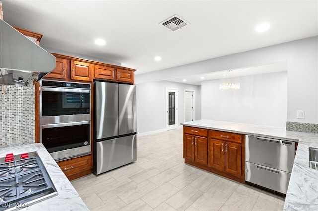 kitchen with backsplash, light stone counters, stainless steel appliances, island range hood, and a notable chandelier