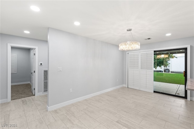 spare room featuring a notable chandelier