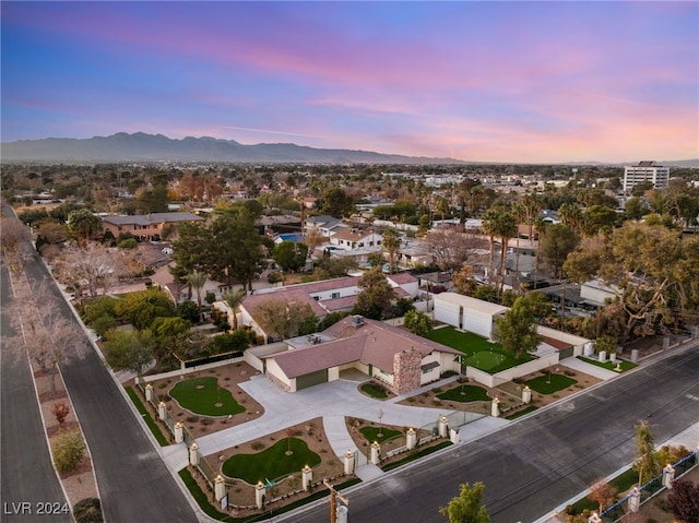 aerial view at dusk featuring a mountain view