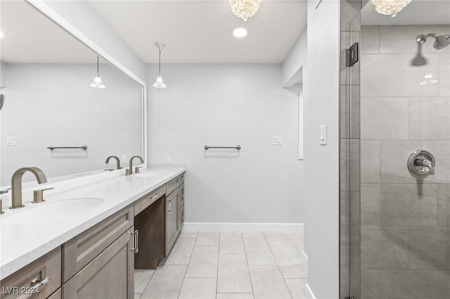 bathroom featuring tile patterned floors, vanity, and a shower with shower door