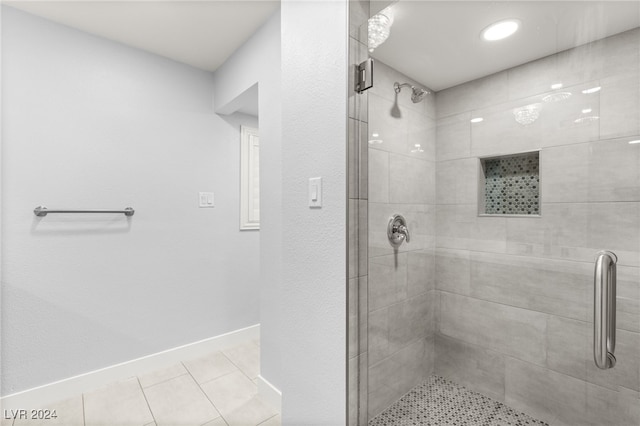 bathroom featuring tile patterned floors and a shower with shower door