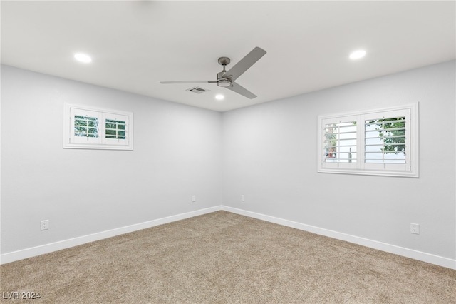 carpeted spare room featuring ceiling fan