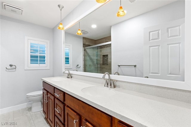 bathroom with tile patterned flooring, toilet, vanity, and walk in shower