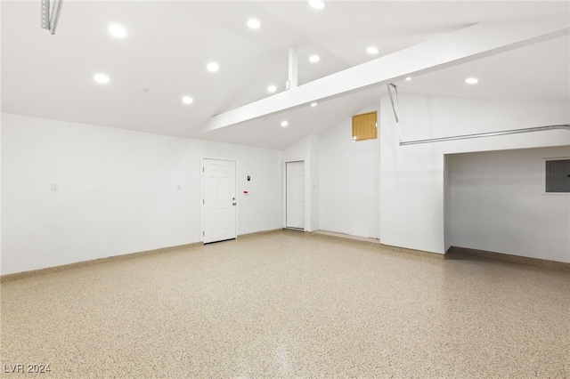 spare room featuring vaulted ceiling with beams