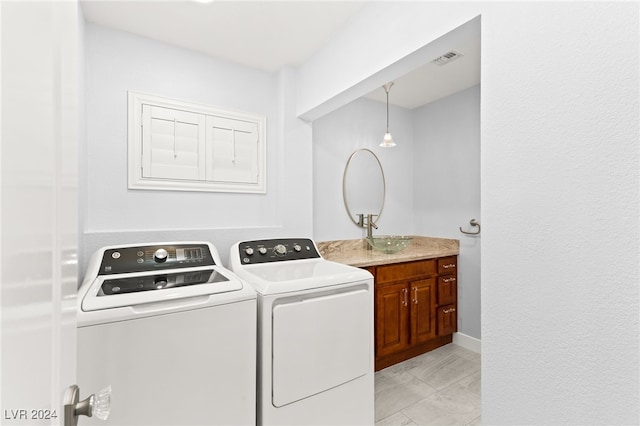 laundry room featuring sink and washing machine and clothes dryer