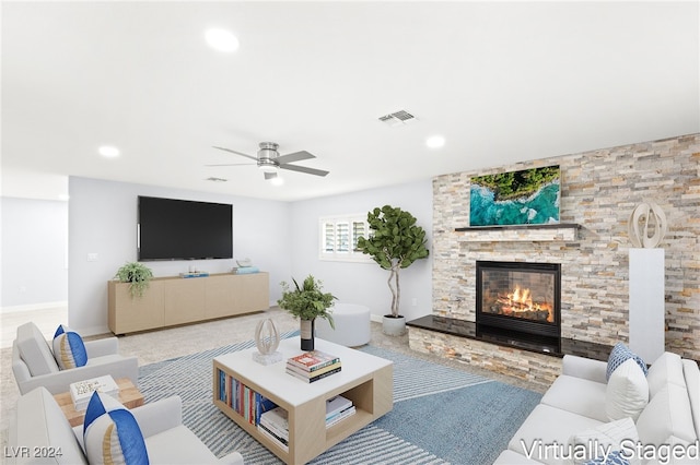 living room with ceiling fan and a fireplace