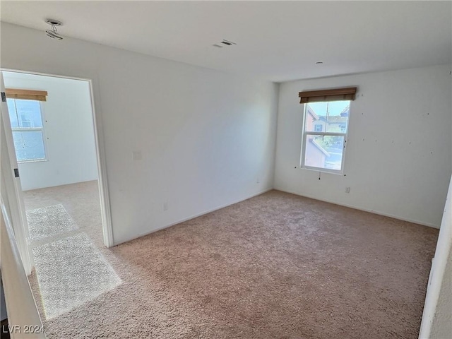 empty room with light colored carpet