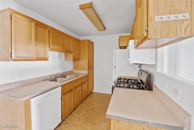 kitchen featuring white appliances and sink