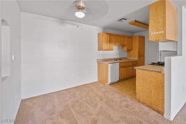 kitchen featuring light carpet, white dishwasher, sink, ceiling fan, and stainless steel gas cooktop