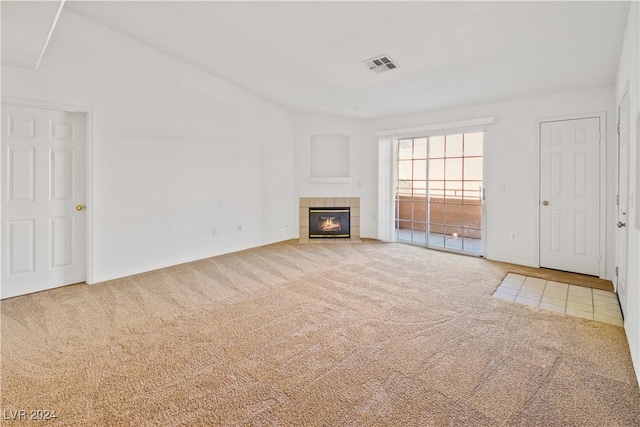 unfurnished living room featuring carpet floors and a fireplace